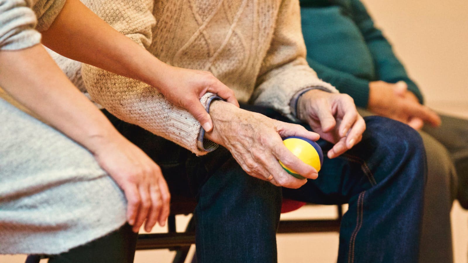 Caring hands holding elderly person's hand showing compassion and support