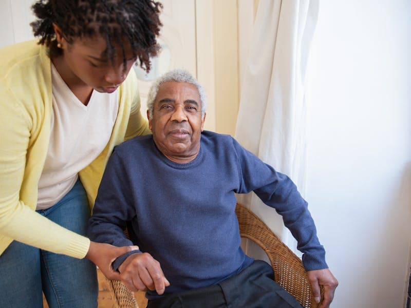 Caregiver assisting a senior woman at home