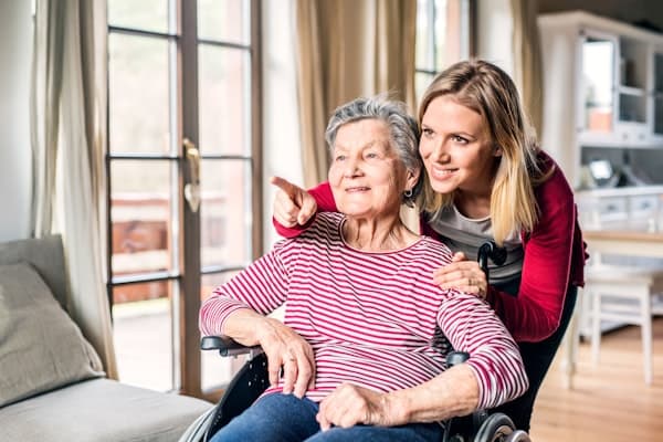 Home care worker supporting elderly person in their own home